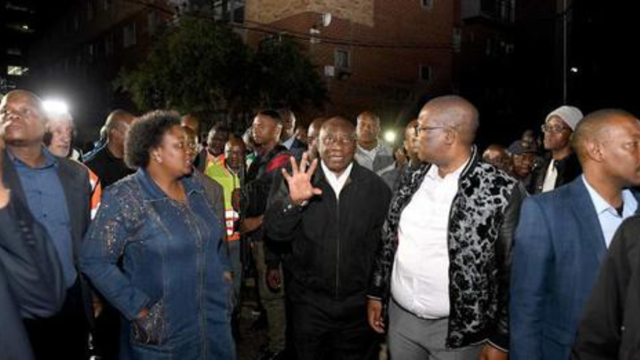 President Cyril Ramaphosa (centre) on a site visit to assess the damage from the fire tragedy at a residential building in Marshalltown, Johannesburg on 31 August 2023