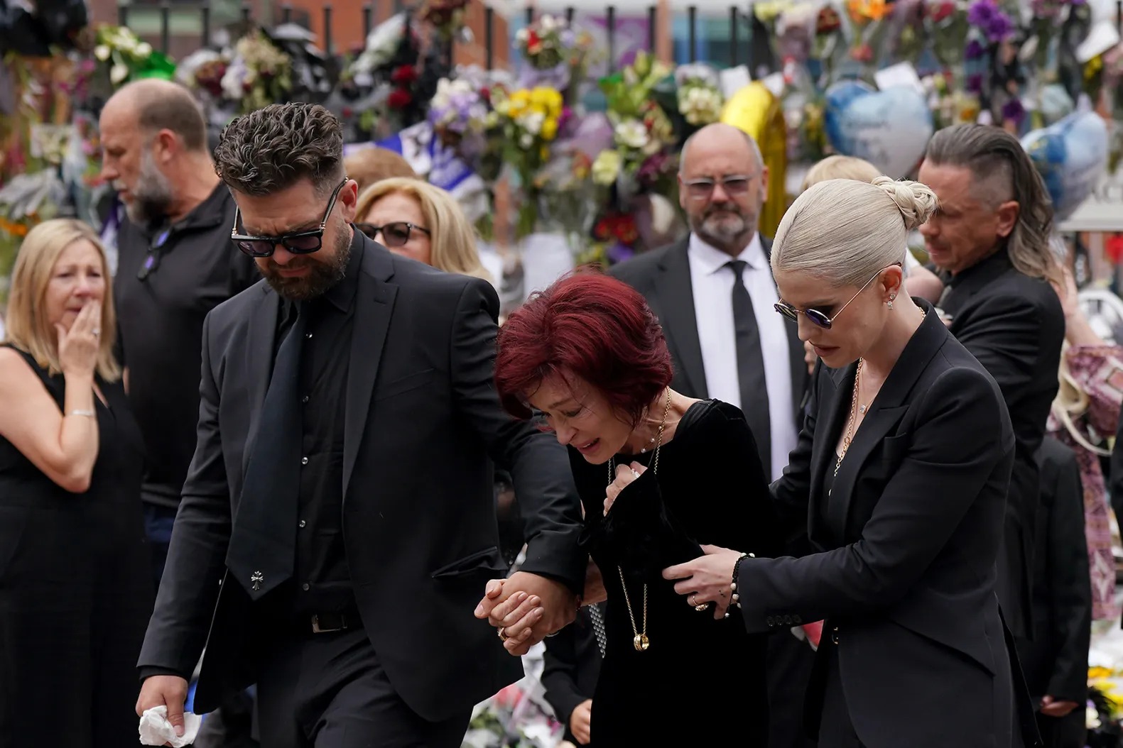 Ozzy Osbourne fans, celebrity funeral UK, Birmingham crowd, Sharon and Kelly Osbourne, Aston Villa final concert, public tribute, Black Sabbath legend, music mourners UK, Prince of Darkness tribute, Joburg ETC