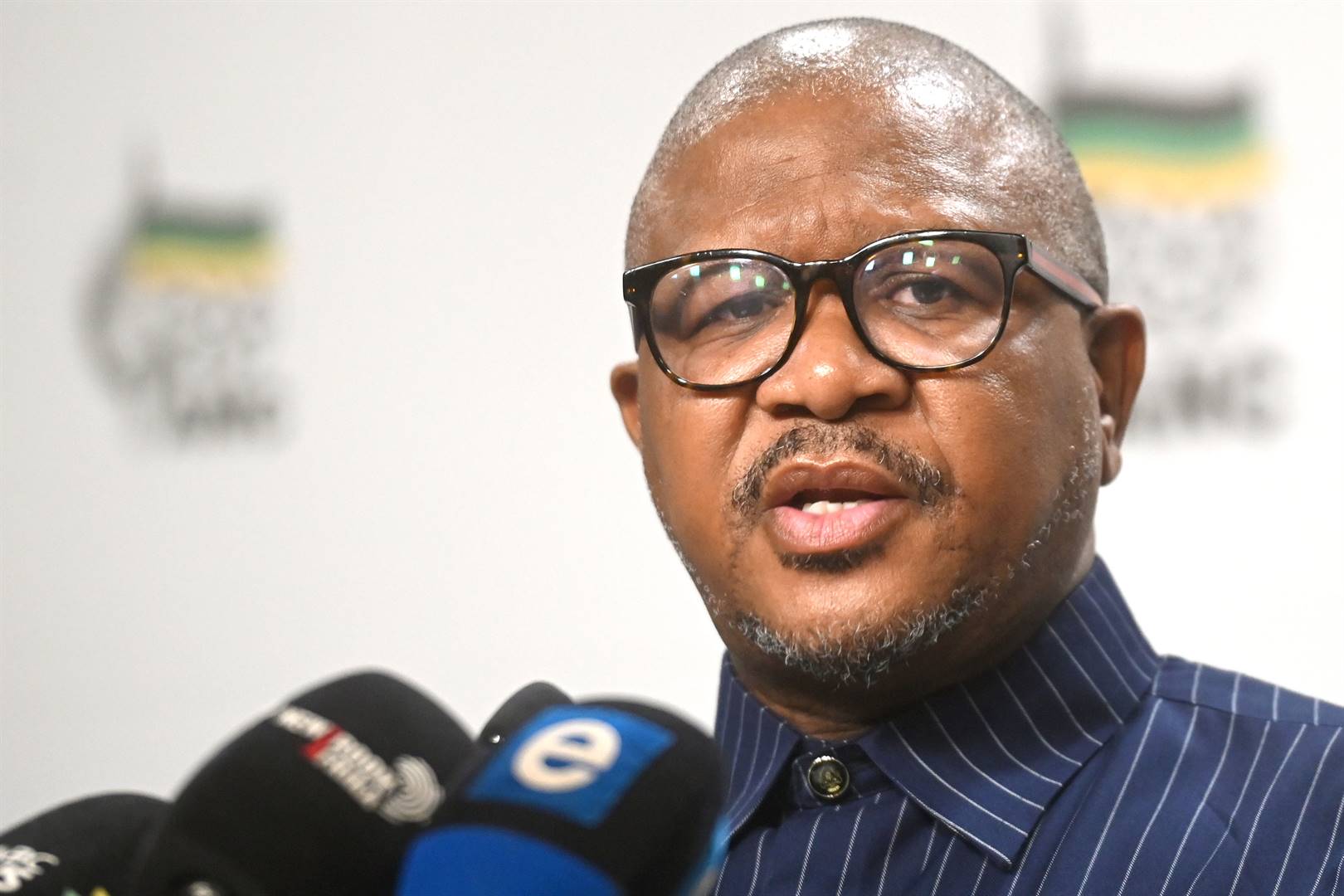 Malusi Gigaba speaking at ANC event, Senzo Mchunu looking serious, Fikile Mbalula addressing media, ANC headquarters in Johannesburg, ANC internal conflict, political analyst interview, Joburg ETC