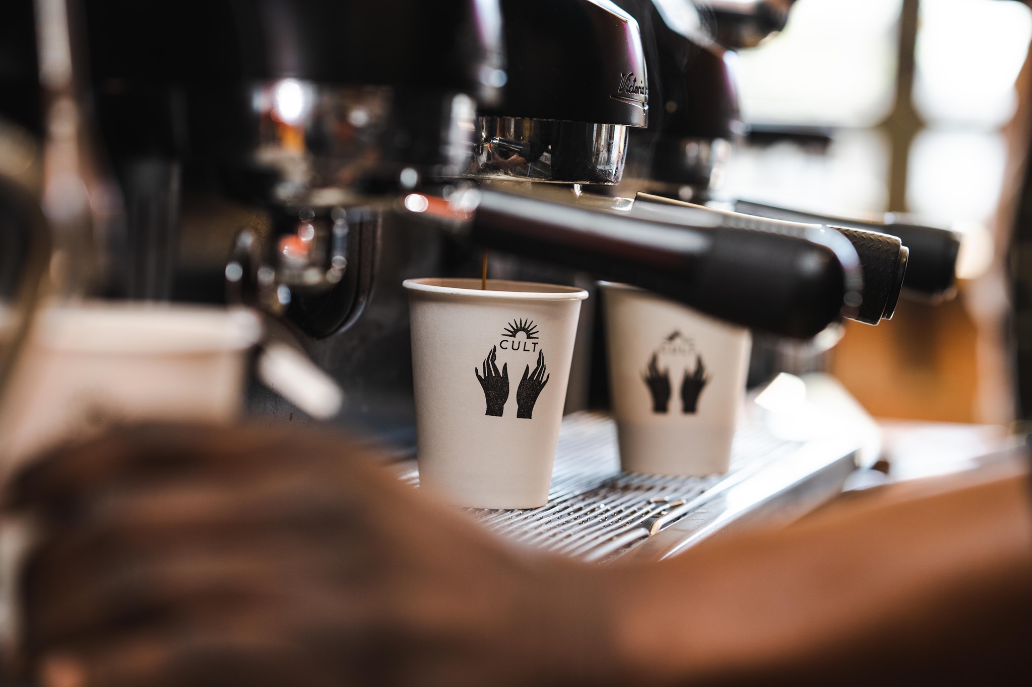 Cult Coffee Co Johannesburg, Kramerville café, artisan coffee Sandton, cosy café interior, barista pouring latte, fresh pastries and sandwiches, breakfast spot Joburg, specialty coffee culture, local coffee shop Johannesburg