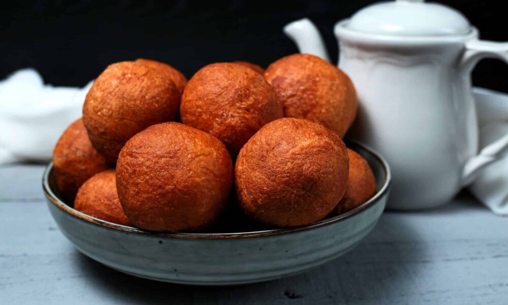 amagwinya South Africa, vetkoek tradition, fried dough street food, township survival food, South African heritage cuisine, golden bites of resilience, Joburg ETC