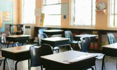 private school classroom South Africa, empty school hallways Johannesburg, parents meeting school fee increase, South African independent school building, worried family budgeting school fees, VAT notice paperwork South Africa, teacher chalkboard classroom, school fee rising envelope, South African flag background education, empty sports field at private school Joburg ETC