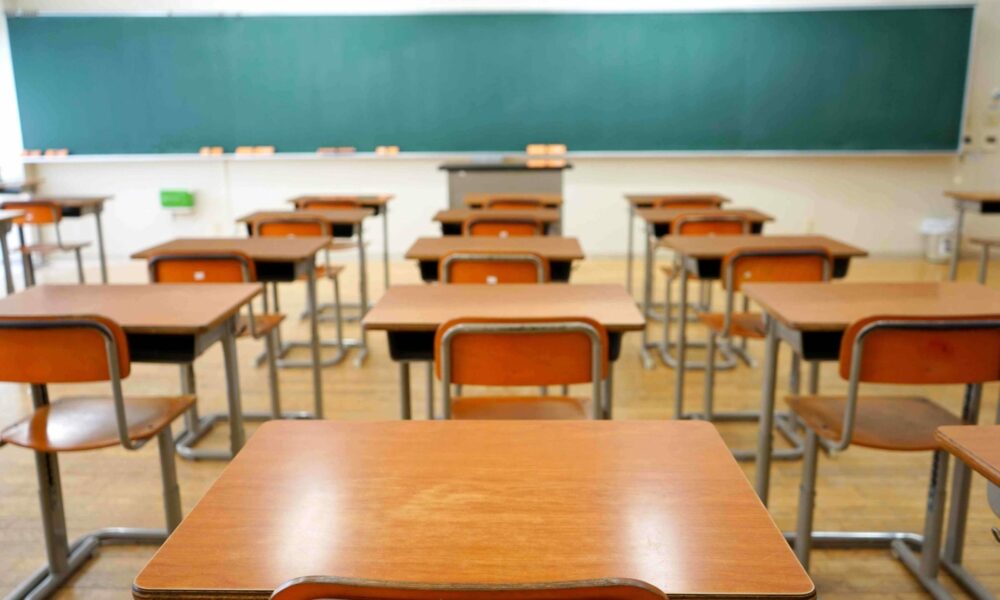 Gauteng parents waiting for school placement updates, worried parent checking phone, South African education, Johannesburg map showing school feeder areas, Gauteng education system, school admissions South Africa Joburg ETC