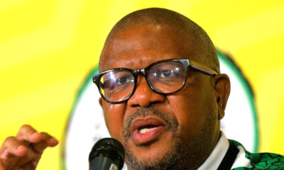 Fikile Mbalula speaking at ANC conference 2025, South Africa flag background, political leader addressing crowd, Joburg ETC