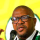 Fikile Mbalula speaking at ANC conference 2025, South Africa flag background, political leader addressing crowd, Joburg ETC