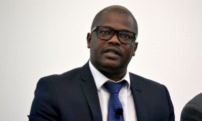 Durban harbour container ships, cargo ships at port, shipping line containers stacked, global shipping routes map, Competition Commission South Africa building, bustling Durban docks at sunset, Maersk container ship, African freight logistics Joburg ETC