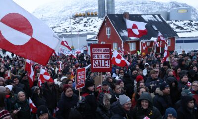 Greenland Nuuk skyline winter, Greenland Arctic town harbour scene, Greenland community preparing supplies, Greenland coastal settlement under dramatic sky, Joburg ETC