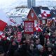 Greenland Nuuk skyline winter, Greenland Arctic town harbour scene, Greenland community preparing supplies, Greenland coastal settlement under dramatic sky, Joburg ETC