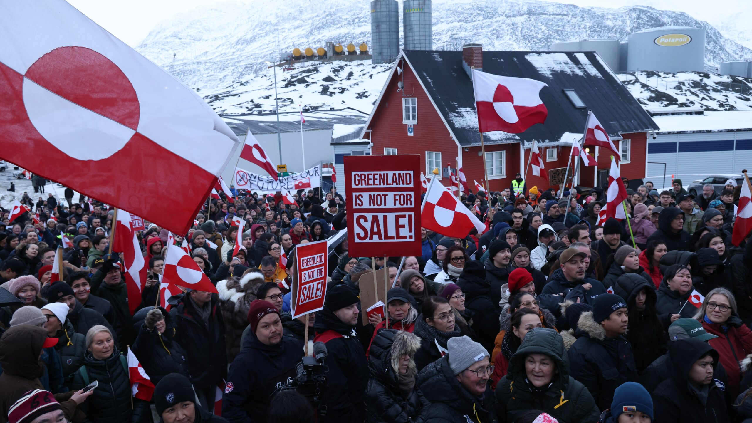 Greenland Nuuk skyline winter, Greenland Arctic town harbour scene, Greenland community preparing supplies, Greenland coastal settlement under dramatic sky, Joburg ETC