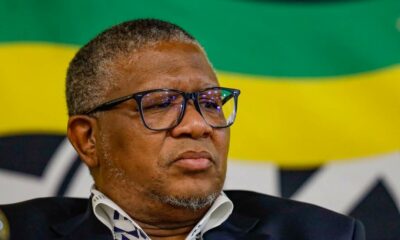 Fikile Mbalula speaking at Polokwane event, ANC rally on economic transformation, crowd listening to political speech, South African flag backdrop, Joburg ETC