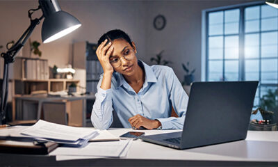 South African small business owner working late, entrepreneur stress South Africa office desk, tired SME founder laptop night, business burnout South Africa 2025, small business productivity loss SA, Emotional Tax report South Africa, Xero South Africa small business survey, overwhelmed entrepreneur paperwork desk, SME financial management South Africa, Joburg ETC