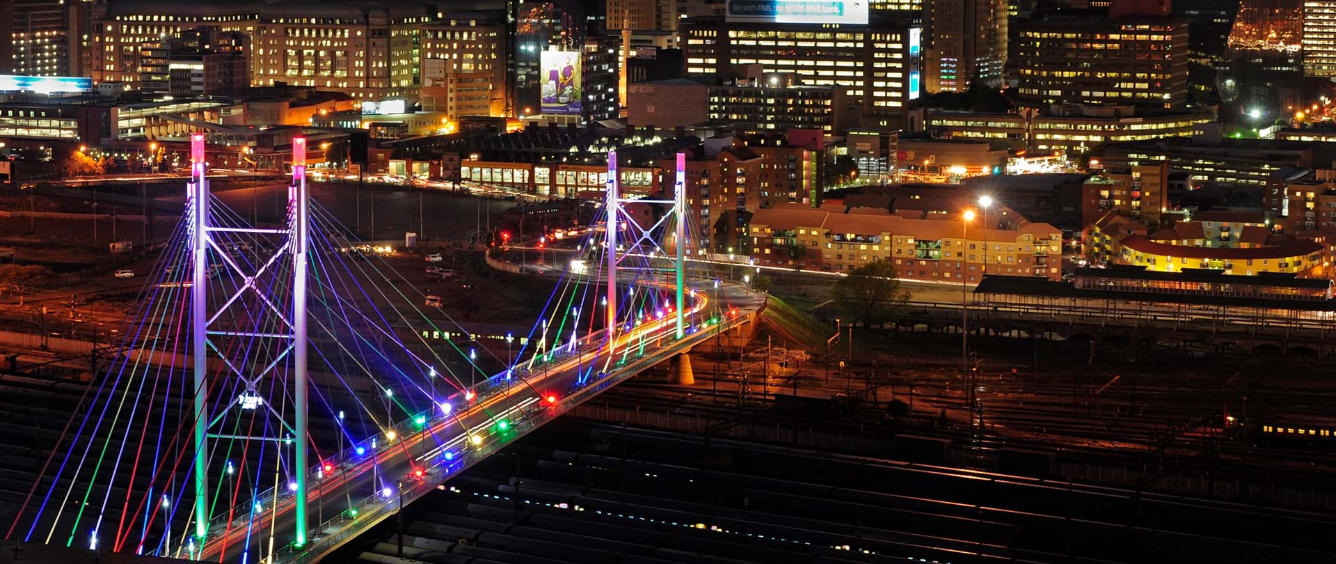 Night photography Johannesburg, Nelson Mandela Bridge at night, Sandton skyline 2026, Maboneng neon lights, Munro Drive viewpoint skyline, The Wilds Houghton night view, Carlton Centre Top of Africa lights, Montecasino night architecture, Villa Simonne fairy lights, Emmarentia Dam reflections, Joburg city lights panorama, Joburg ETC