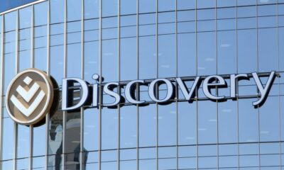 Discovery logo South Africa, Adrian Gore Discovery founder, Vitality rewards programme South Africa, Discovery Bank app South Africa, Discovery Health offices Johannesburg, Old Mutual headquarters South Africa, Sanlam head office Cape Town, OUTsurance branding South Africa, Momentum insurance South Africa, South African insurance industry media coverage, Joburg ETC