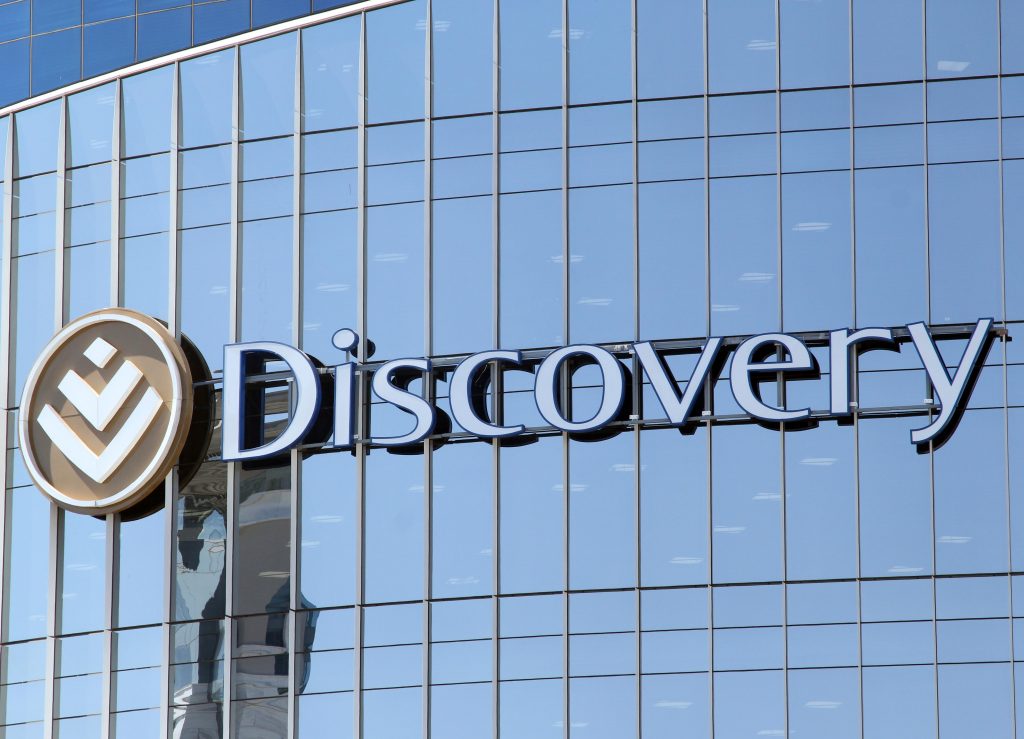 Discovery logo South Africa, Adrian Gore Discovery founder, Vitality rewards programme South Africa, Discovery Bank app South Africa, Discovery Health offices Johannesburg, Old Mutual headquarters South Africa, Sanlam head office Cape Town, OUTsurance branding South Africa, Momentum insurance South Africa, South African insurance industry media coverage, Joburg ETC