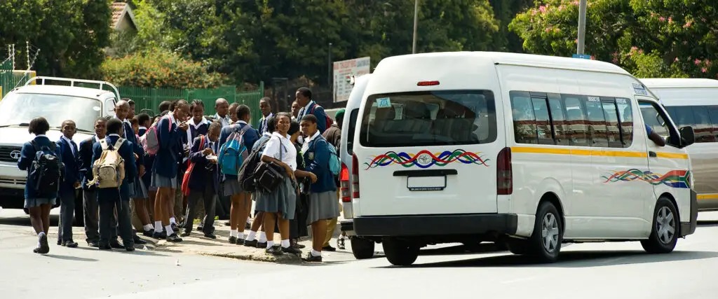Scholar transport taxi Cape Town, overloaded school transport South Africa, Mitchells Plain primary school traffic stop, children exiting scholar transport taxi, Cape Town Transport Enforcement Unit operation, school transport safety South Africa, Joburg ETC