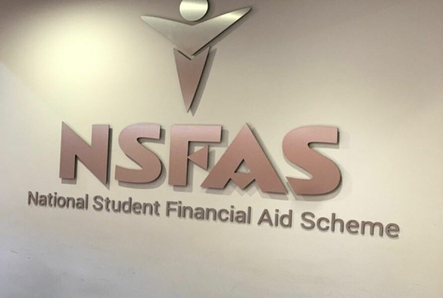 NSFAS offices South Africa, Enoch Godongwana speaking, South African university campus, student registration queue South Africa, Dawie Roodt economist South Africa, Michael Jordaan Bank Zero, higher education funding crisis SA, Joburg ETC