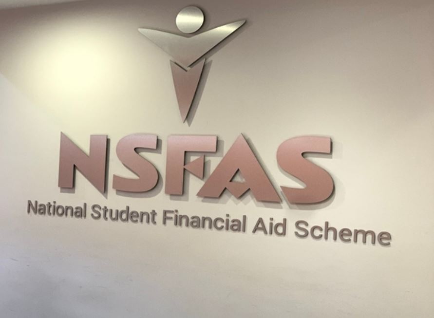 NSFAS offices South Africa, Enoch Godongwana speaking, South African university campus, student registration queue South Africa, Dawie Roodt economist South Africa, Michael Jordaan Bank Zero, higher education funding crisis SA, Joburg ETC