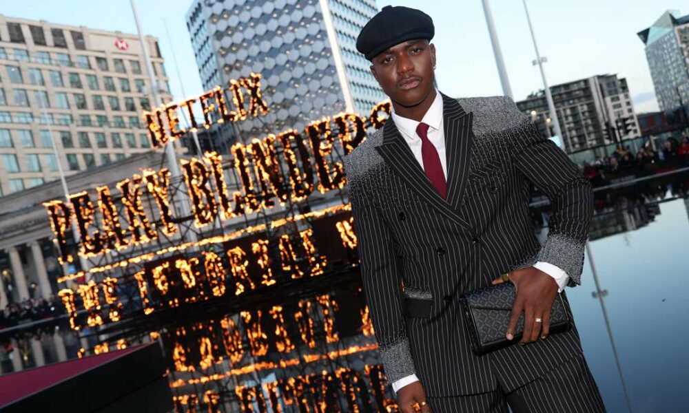 Moghelingz Peaky Blinders premiere, Banele Ndaba red carpet Birmingham, Peaky Blinders The Immortal Man premiere, South African TikTok star Moghelingz, Sihle Masango pinstripe suit design, African beadwork fashion red carpet, Birmingham Symphony Hall premiere event, South African creator at Netflix premiere, Moghelingz fashion Peaky Blinders style, Standerton Mpumalanga influencer success story, Joburg ETC