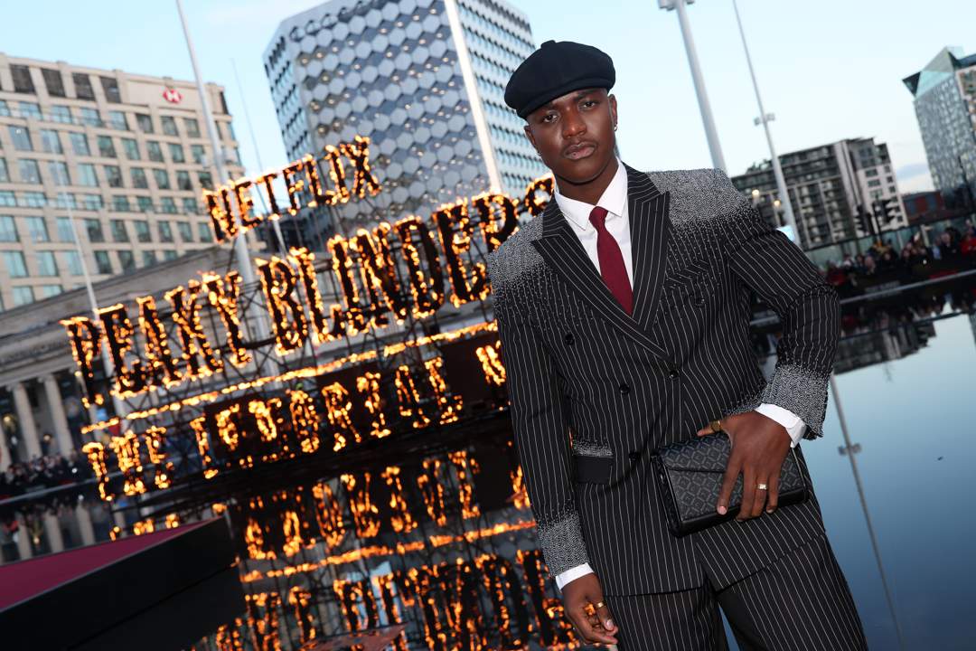 Moghelingz Peaky Blinders premiere, Banele Ndaba red carpet Birmingham, Peaky Blinders The Immortal Man premiere, South African TikTok star Moghelingz, Sihle Masango pinstripe suit design, African beadwork fashion red carpet, Birmingham Symphony Hall premiere event, South African creator at Netflix premiere, Moghelingz fashion Peaky Blinders style, Standerton Mpumalanga influencer success story, Joburg ETC